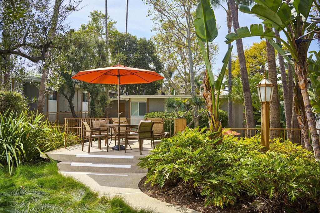 a patio with tables and an umbrella