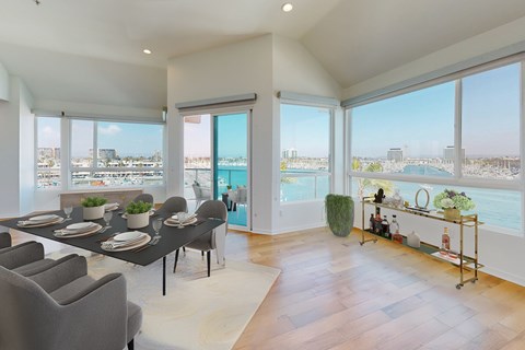 A dining room with a table set for six with a view of the city.