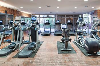 A gym with treadmills, exercise bikes, and other equipment.