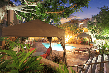 A poolside area with a tent and chairs.
