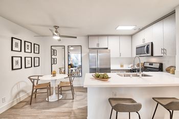 A modern kitchen with a dining table and chairs.