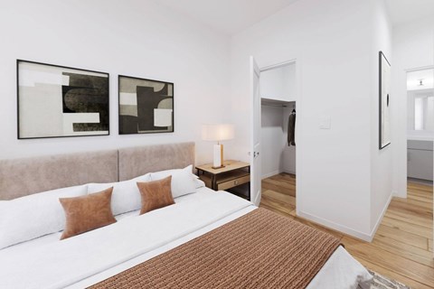 A bedroom with a large bed and two abstract paintings on the wall.