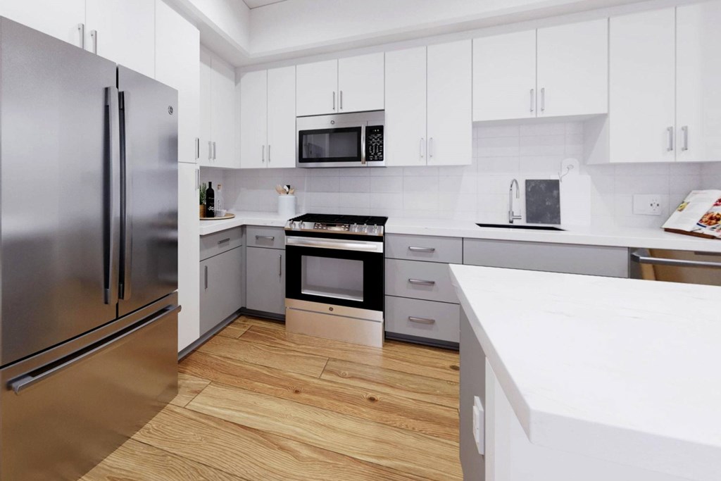 A modern kitchen with a refrigerator, oven, microwave, and sink at The Villas at Anacapa Canyon, Camarillo, 93012