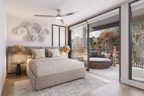 A bedroom with a large bed and a ceiling fan.