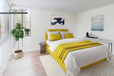 A bedroom with a large bed and a potted plant.