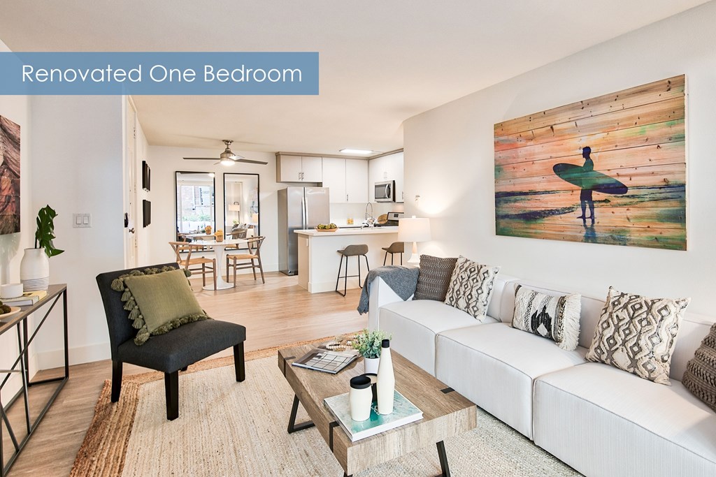 A living room with a surfboard painting on the wall.