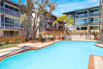 A swimming pool in front of apartment buildings.