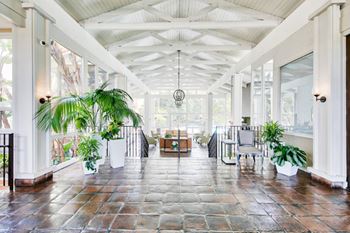 A large open room with a tiled floor and a white ceiling at Mediterranean Village Costa Mesa, Costa Mesa, CA
