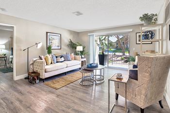 A living room with a white sofa and a wooden coffee table.