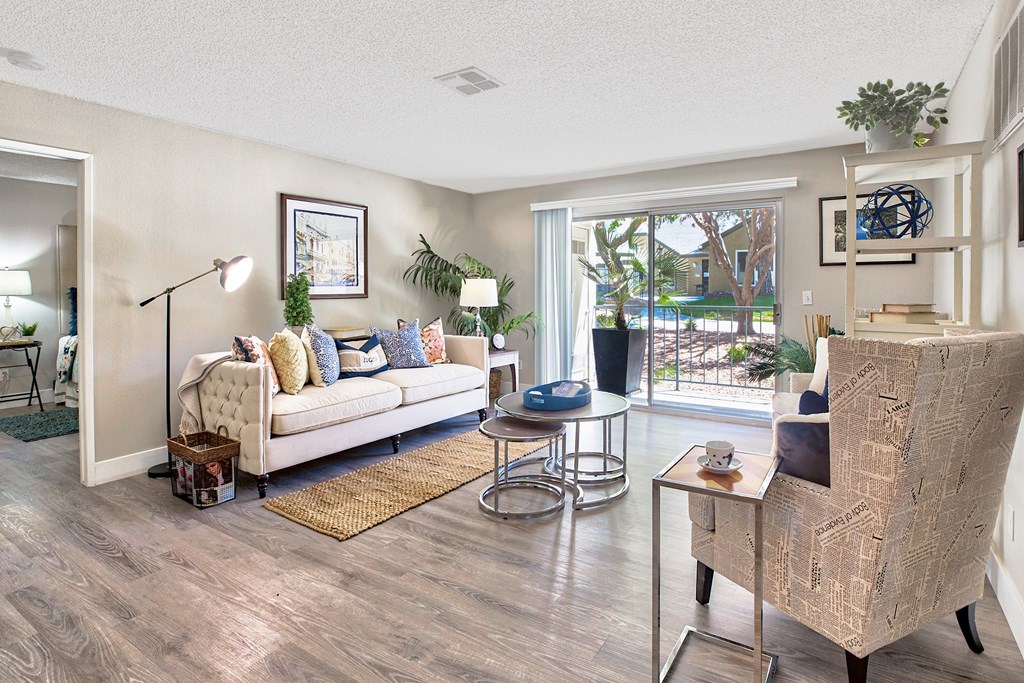 A living room with a white sofa and a wooden coffee table at Mountain Vista, Victorville, CA