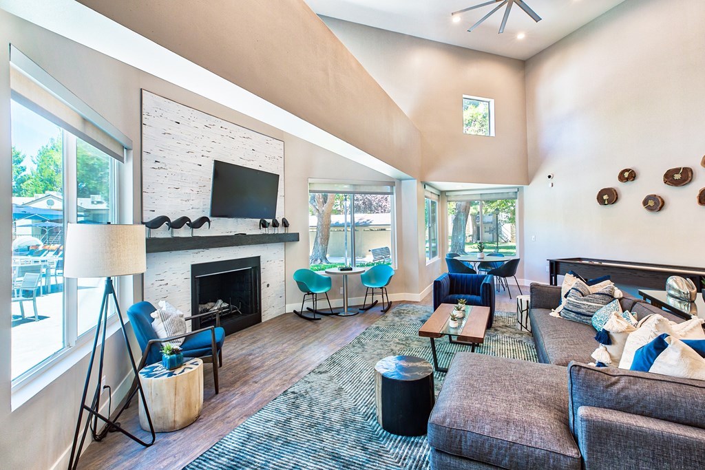 A living room with a fireplace and a television at Mountain Vista, Victorville, CA