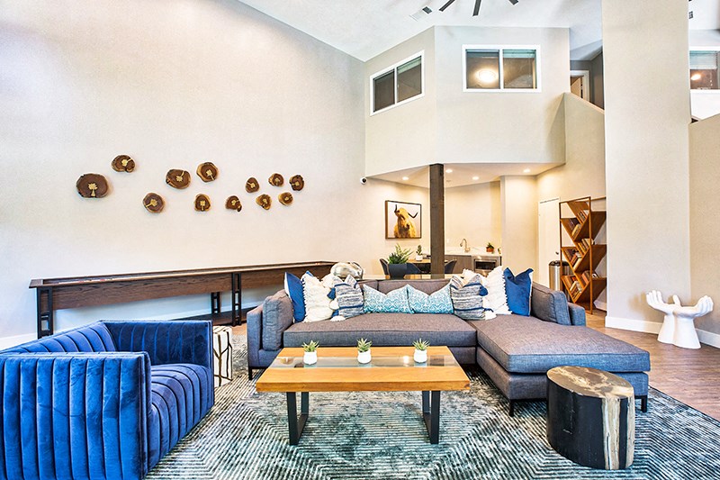 a living room with blue couches and a coffee table