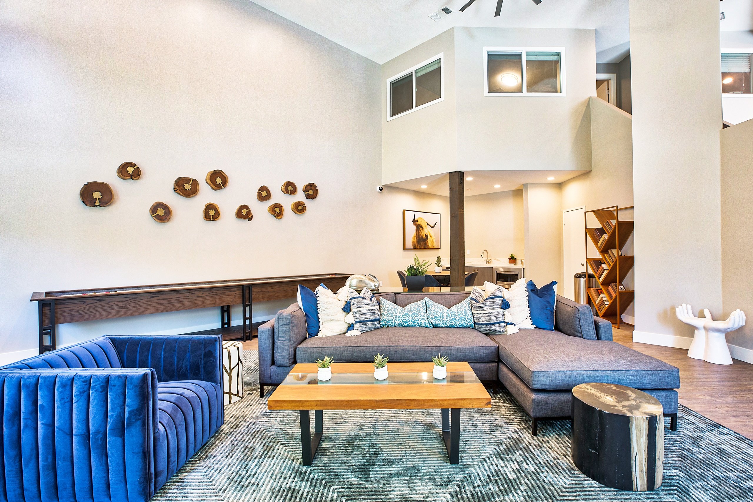 A living room with a blue couch and a wooden coffee table.