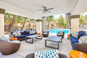 A patio with a pool and furniture.