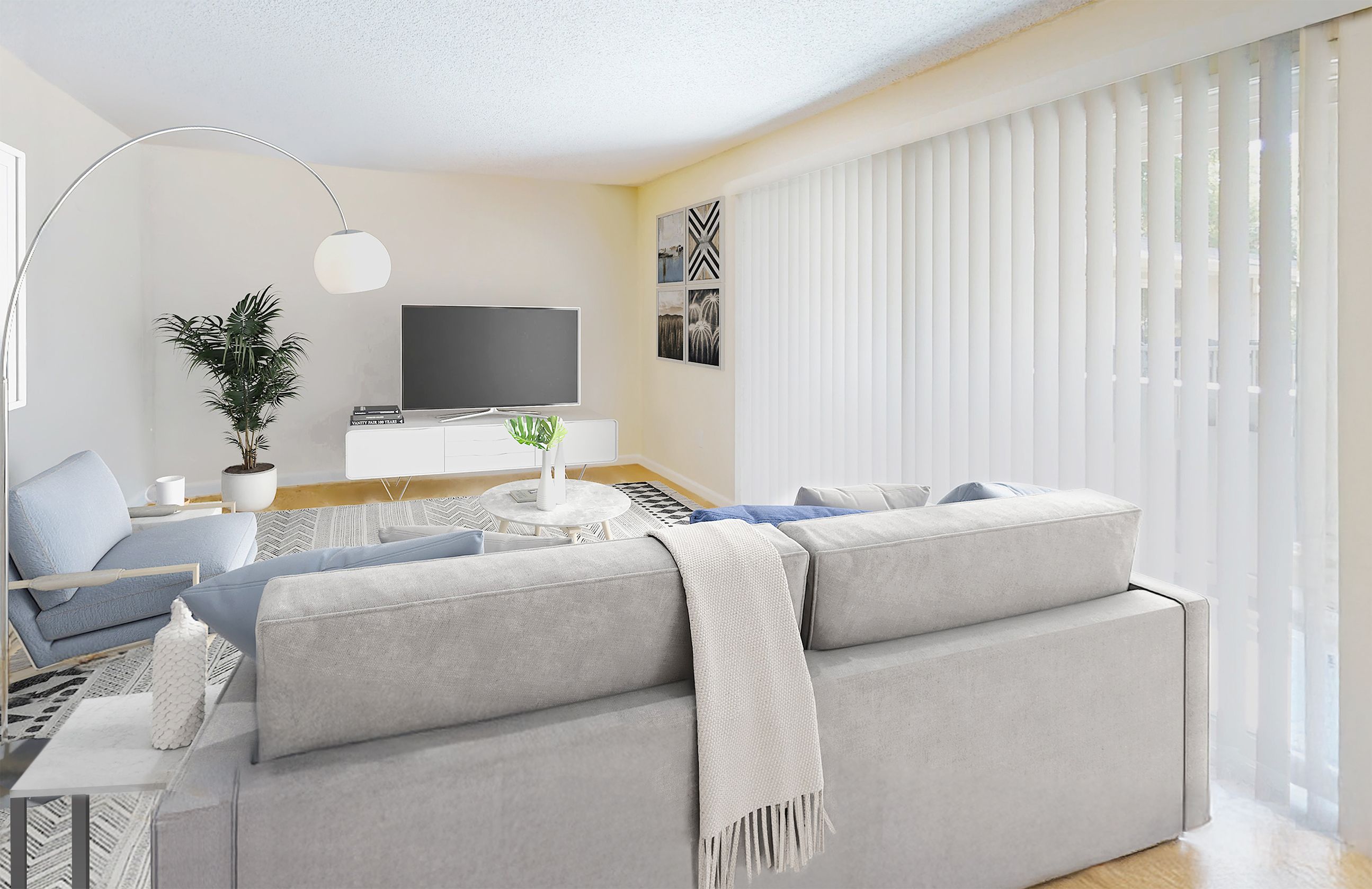 A modern living room with a grey sofa and a television.
