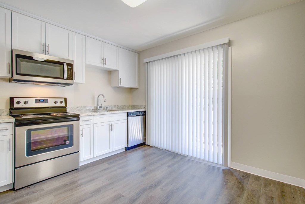A kitchen with a stove, microwave, and cabinets at Pleasanton Heights, California