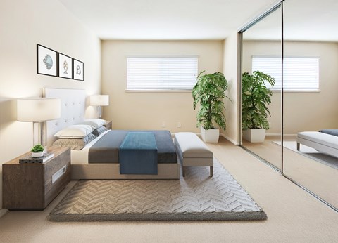 A bedroom with a bed, nightstand, and potted plants.