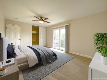a bedroom with a bed and a ceiling fan