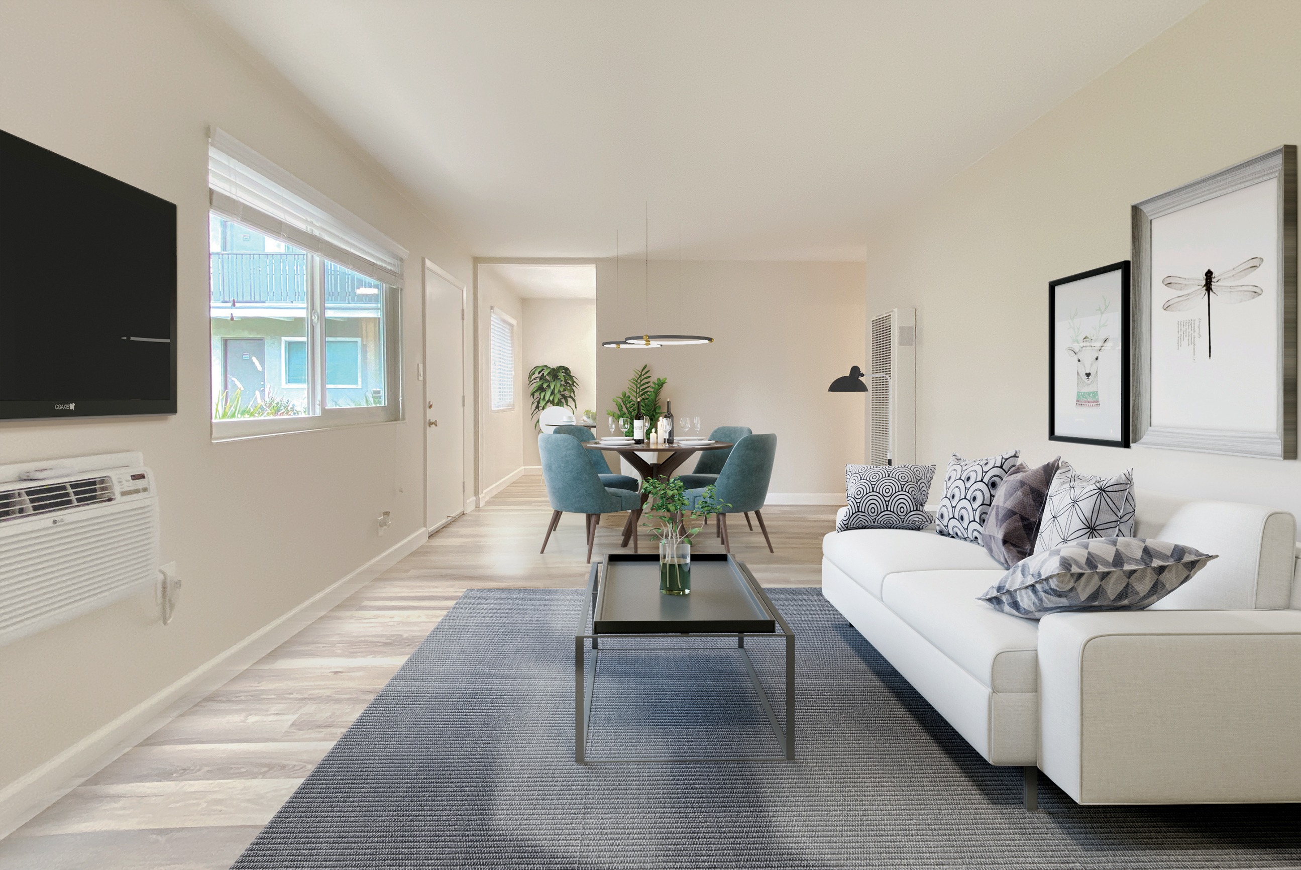 A living room with a white couch and a coffee table.
