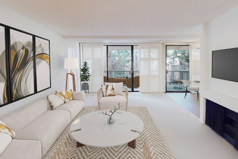 A living room with a white couch, a coffee table, and a painting on the wall.