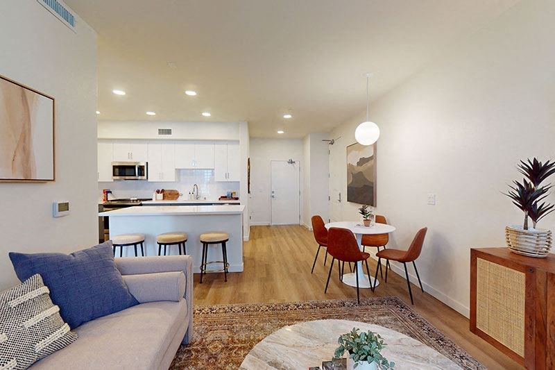 a living room and kitchen with a table and chairs at The Villas at Anacapa Canyon, California