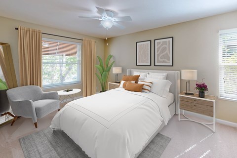 A bedroom with a large bed, a chair, and a ceiling fan.