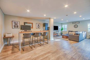 A living room with a couch, a television, and a bar area at Villa Vicente, Los Angeles, CA, 90019