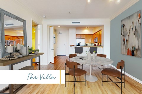 A dining room with a table set for four.