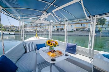 The interior view of a Duffy Boat, with snacks and pillows