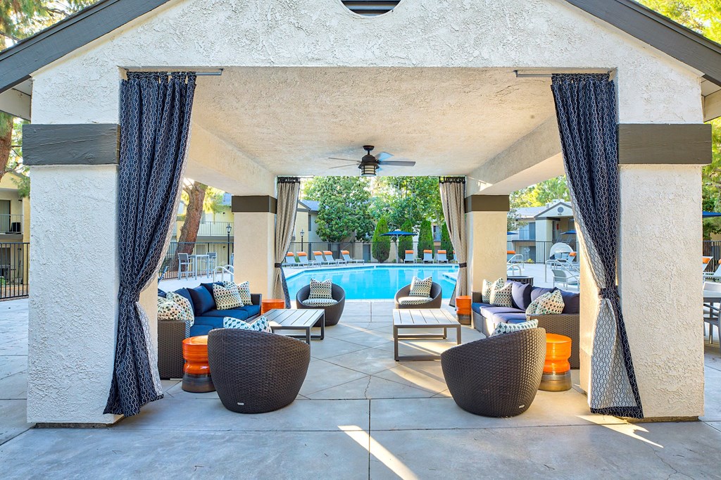 A patio with a pool and furniture at Mountain Vista, Victorville, CA