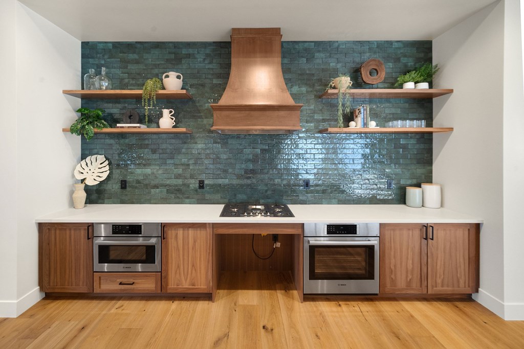 A kitchen with wooden cabinets and a copper hood at The Villas at Anacapa Canyon, Camarillo, 93012