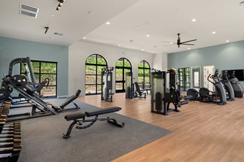 A gym with a variety of equipment including treadmills, weights, and a bench at The Villas at Anacapa Canyon, Camarillo