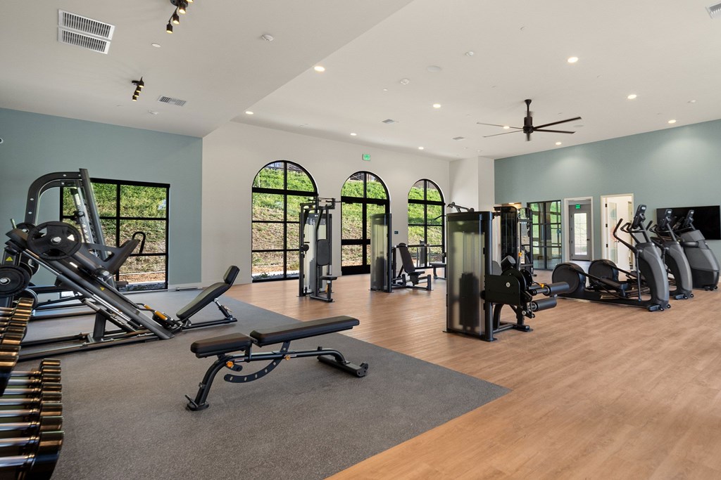 A gym with a variety of equipment including treadmills, weights, and a bench at The Villas at Anacapa Canyon, Camarillo, 93012