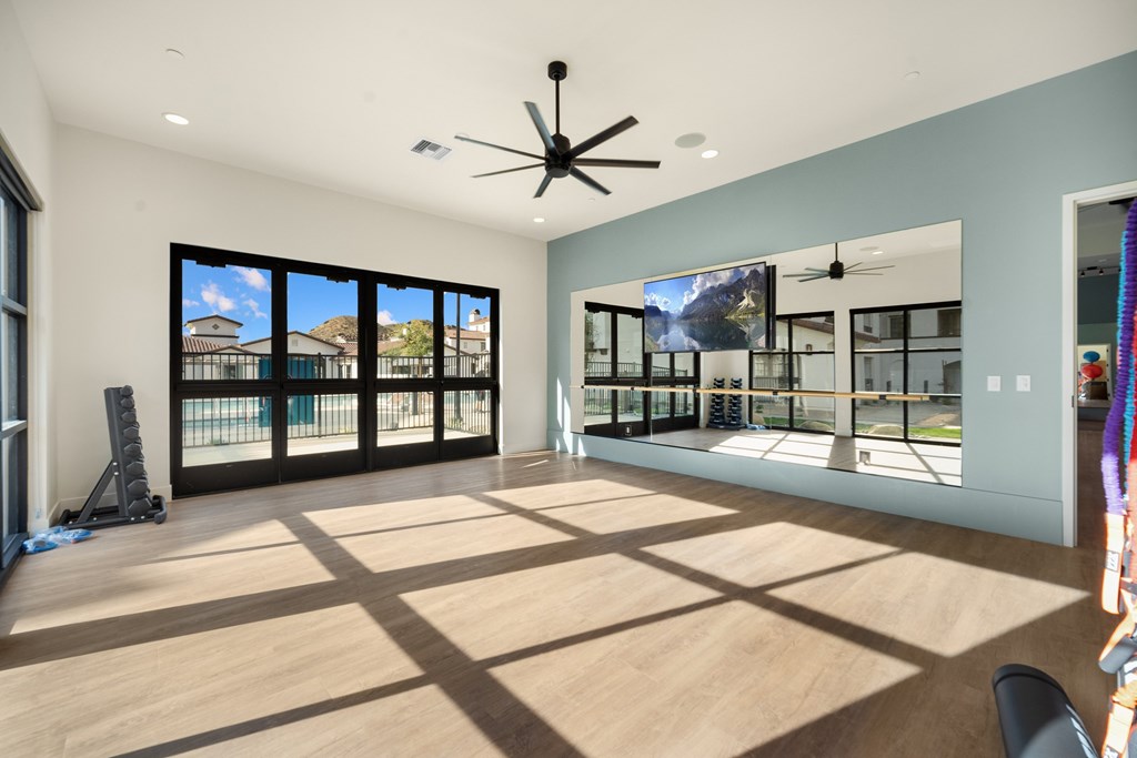 A room with a ceiling fan and a large window overlooking a balcony at The Villas at Anacapa Canyon, Camarillo, 93012