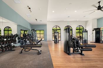 A gym with a variety of equipment including treadmills, weights, and exercise machines at The Villas at Anacapa Canyon, Camarillo