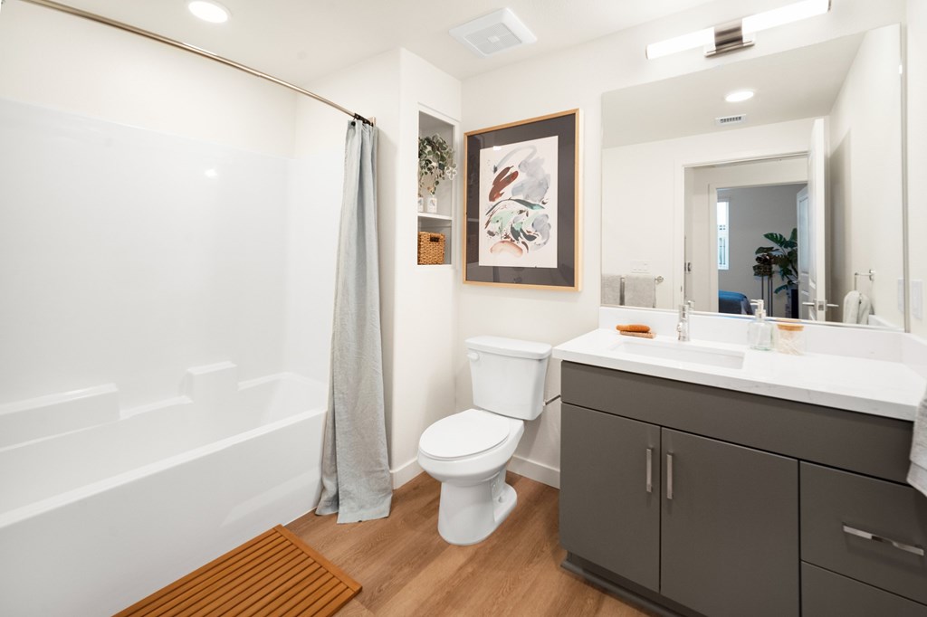 A bathroom with a white toilet, a white sink, and a white bathtub at The Villas at Anacapa Canyon, Camarillo, 93012