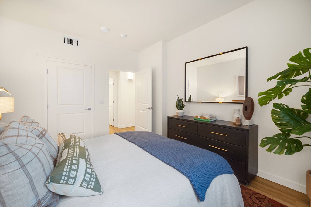 A bedroom with a bed, a dresser, and a mirror at The Villas at Anacapa Canyon, Camarillo, 93012