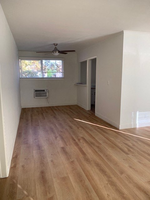 an empty living room with a hard wood floor
