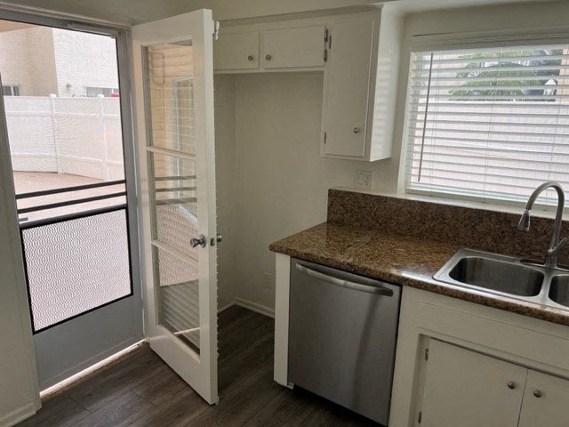 a kitchen with a sink and a door to a balcony