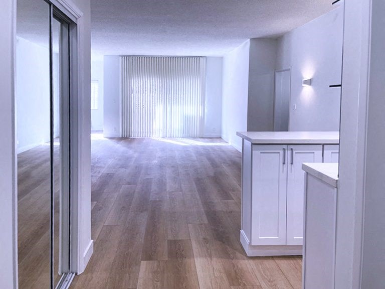 Kitchen with White Cabinets and Living Room with Hard Floor