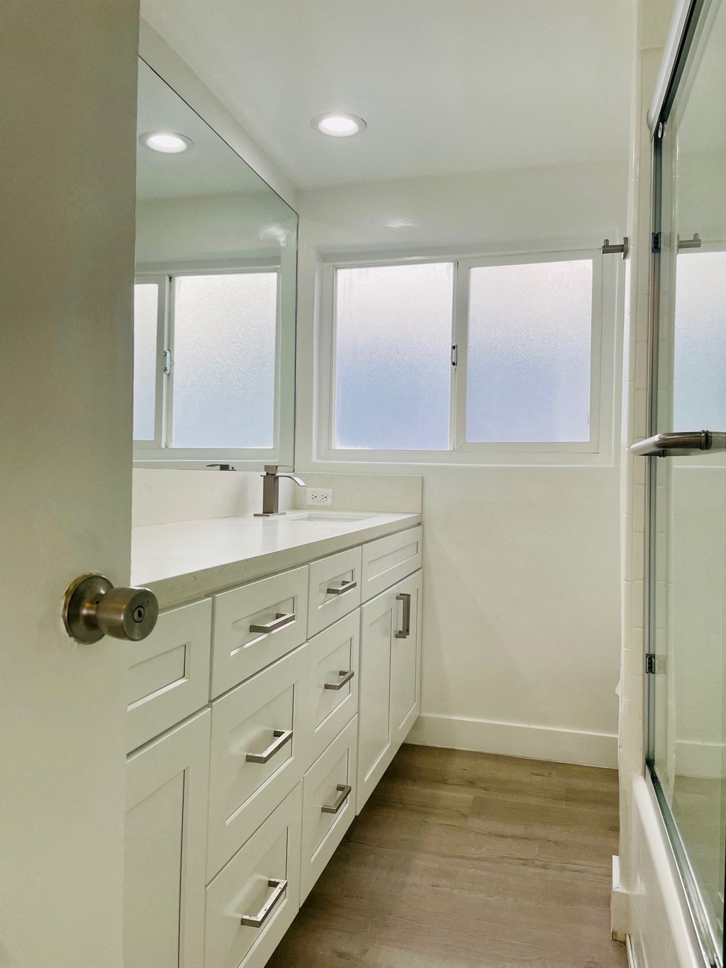 Bathroom with White Cabinets and Window