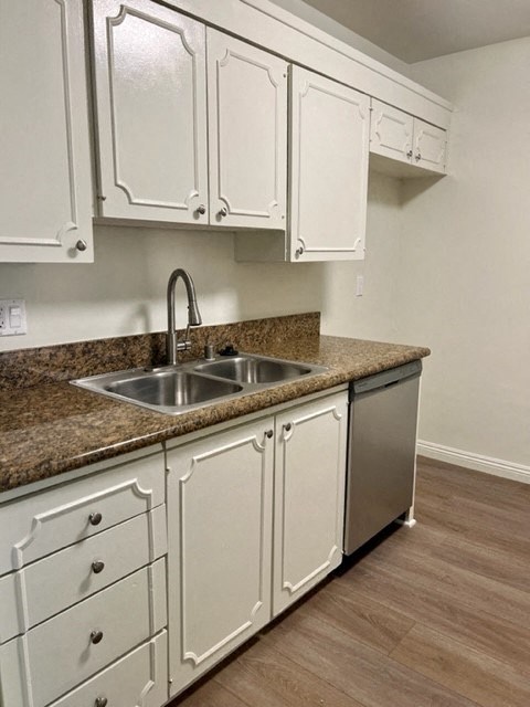 a kitchen with white cabinets and a sink