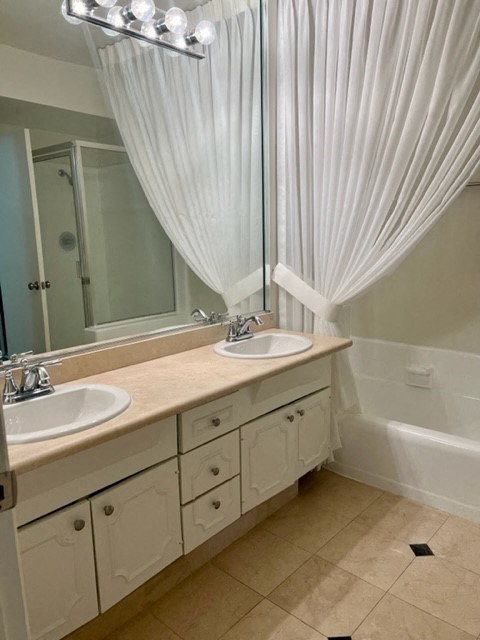a bathroom with two sinks and a large mirror