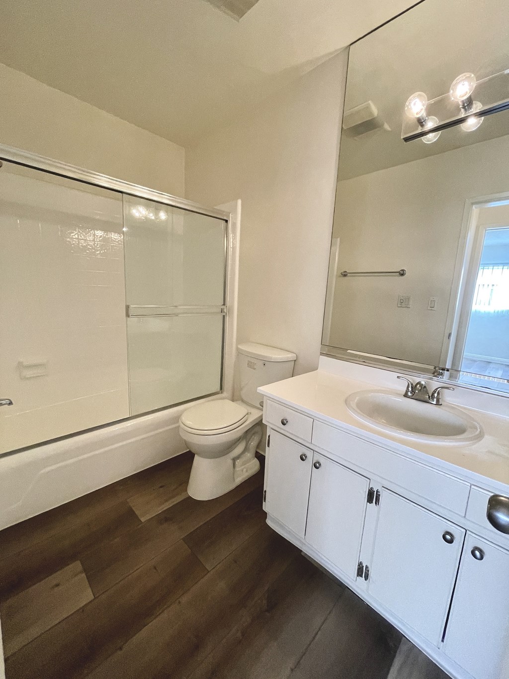 Bathroom with White Cabinets, Hardwood Floors and Bathtub/Shower