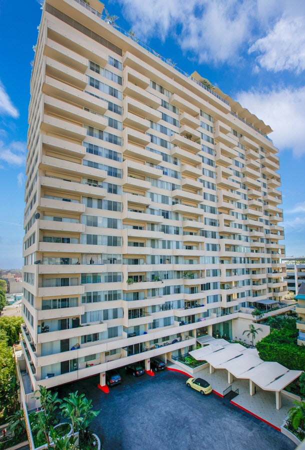 A tall building with a lot of windows and balconies.