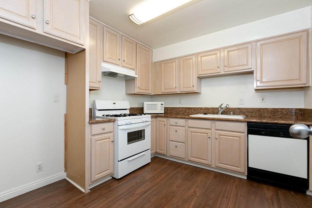 Kitchen with Wood Cabinets and White Appliances