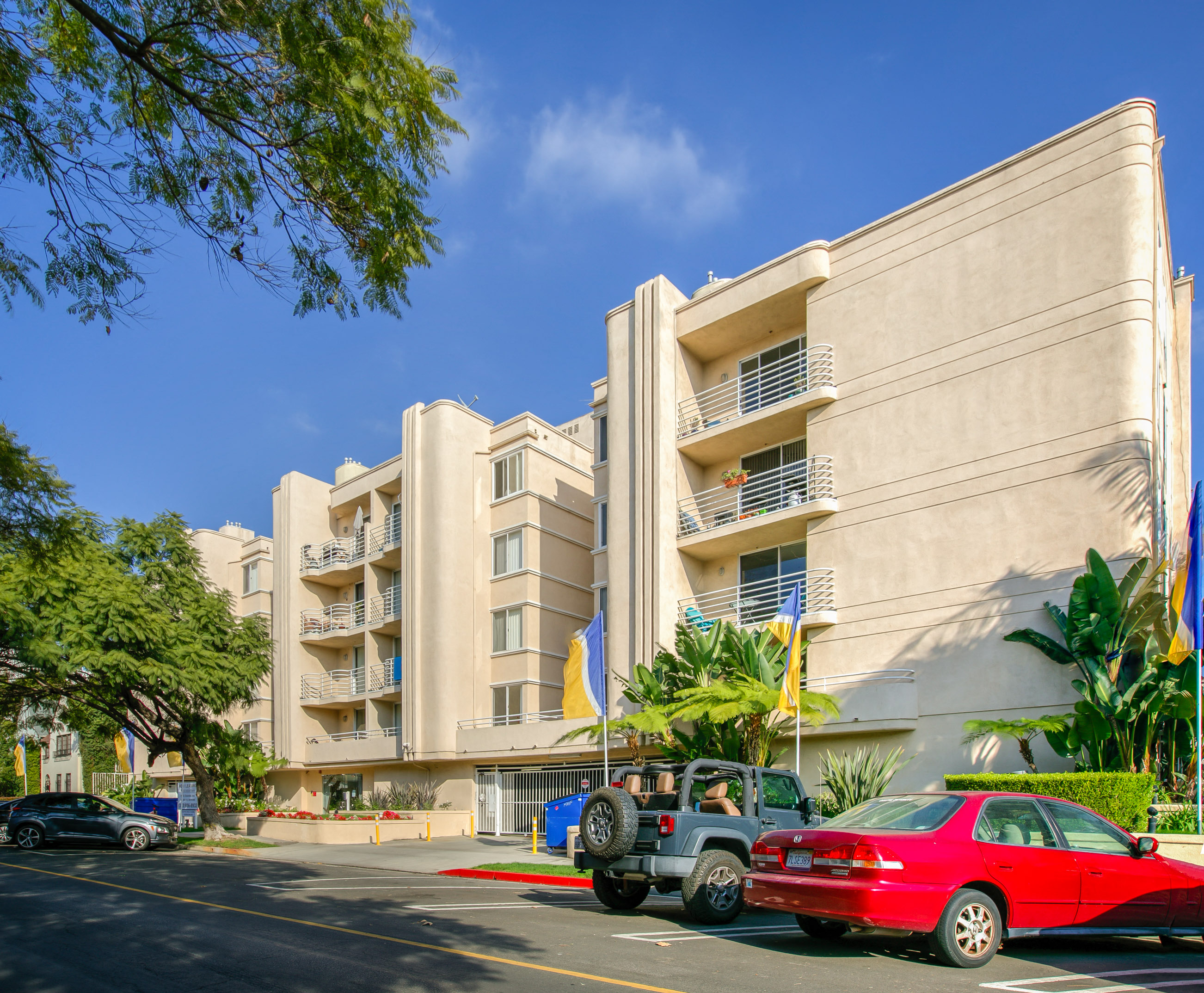 a large beige building with cars parked in front of it