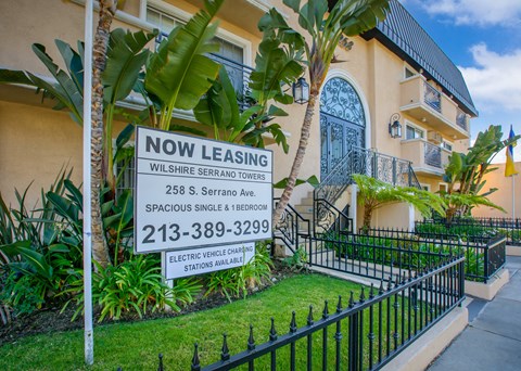 a now leasing sign in front of a house