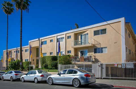 a large building with cars parked in front of it