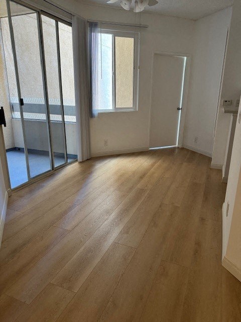 a living room with a wood floor and a glass door